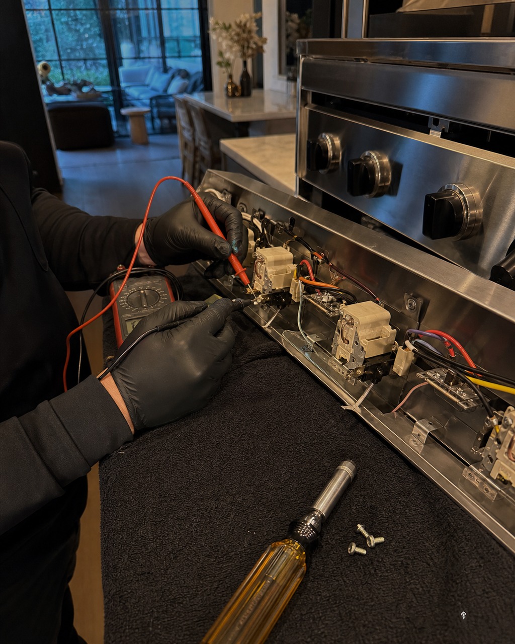 Technician reading a Viking range control board with a meter to diagnose an oven F-code